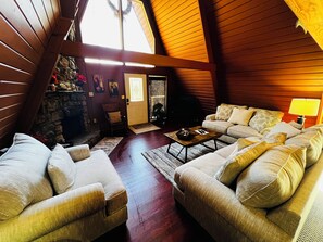 Relax in a spacious living area with a fireplace, sofas, and a chair, perfect for unwinding.
