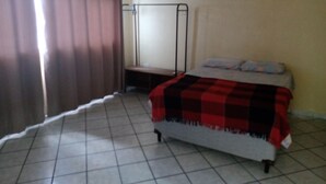 A bedroom with a bed, a bedside table, a wardrobe, and an air conditioning unit on the wall. - 1st floor house in Olinda, whitewashed house, 100 meters from the beach. (Casa Caiada)