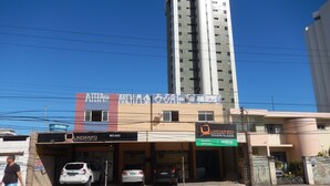 A building with a sign for 'Lindainfo Equipamentos de Serviciais' and a 'Reventa autorizada' sign. - 1st floor house in Olinda, whitewashed house, 100 meters from the beach. (Casa Caiada)