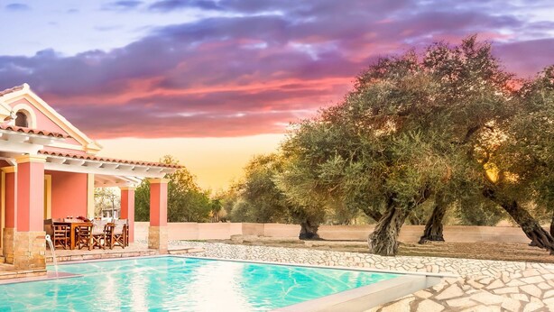 A pool area with a pergola, outdoor seating, and olive trees. - Beach Villa Joanna - Luxury Villa rental in Corfu, Greece (Acharavi)