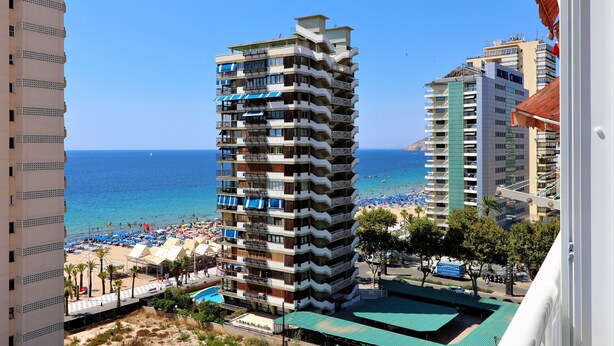 A high-rise hotel with multiple balconies, a pool area, and a beach view. - Baccana 9-4 (Benidorm)