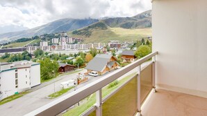 Un balcon avec vue sur la ville et les montagnes.