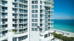 Un hotel di grattacielo con numerosi balconi vista spiaggia.