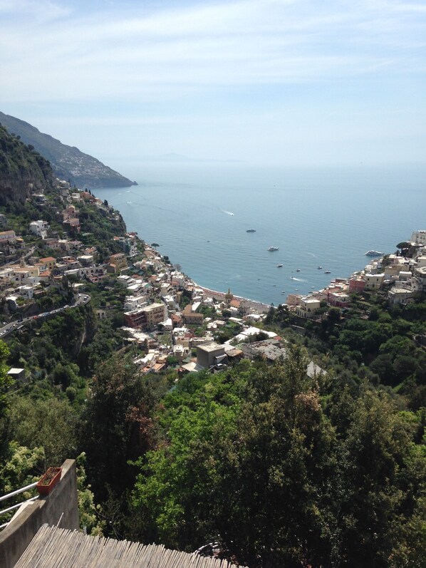 A coastal town with buildings along the hillside and a view of the sea.