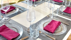 A dining table set for six with clear glassware and red napkins. - Flaminio Penthouse with Spectacular Terrace (Roma)