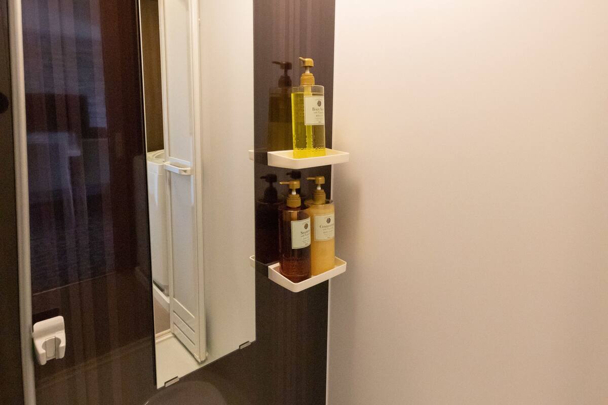 separate bathtub and shower, hair dryer, slippers, towels