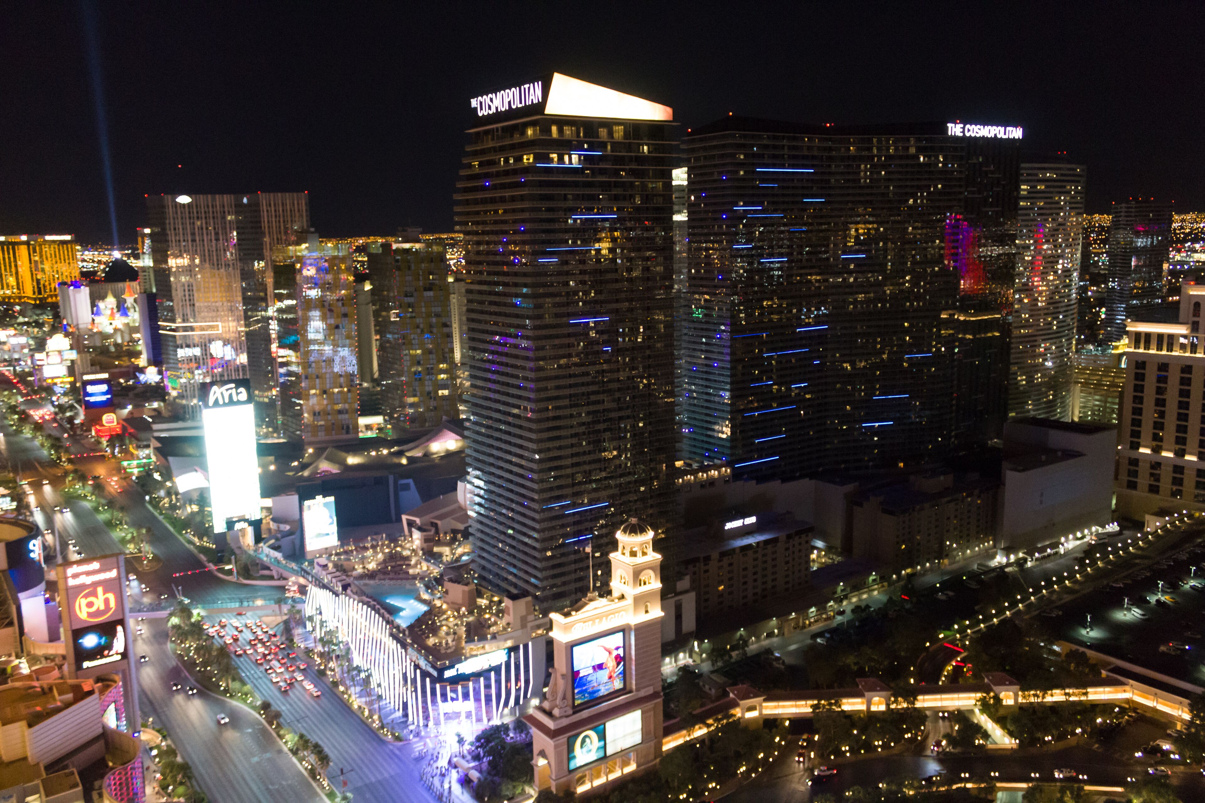 A nighttime cityscape with prominent skyscrapers, including a building with 'The Cosmopolitan' sign.
