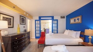 A hotel room with a bed, a bench, a dresser, and a desk. - Stay Together Suites | Cozy Strip Condo (Las Vegas)