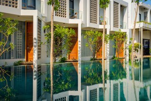 A modern hotel with a pool, balconies, and greenery. - Phka Chan Hotel (Siem Reap)