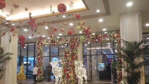 A decorated entrance with a Christmas tree, lights, and ornaments. - Venice Mall Area McKinley Hill Taguig BGC (Taguig)