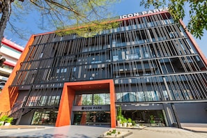 A modern building with a prominent entrance labeled "ICON PARK." - Sleep Z Hostel by Icon Park (Chiang Mai)