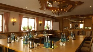 A large dining area with multiple tables set for a meal, featuring a variety of glassware and bottles. - Hotel-Restaurant Hirsch Berghaupten (Berghaupten)