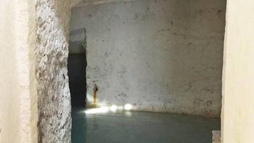 Stroll through this historic passageway to a serene, water-filled space.