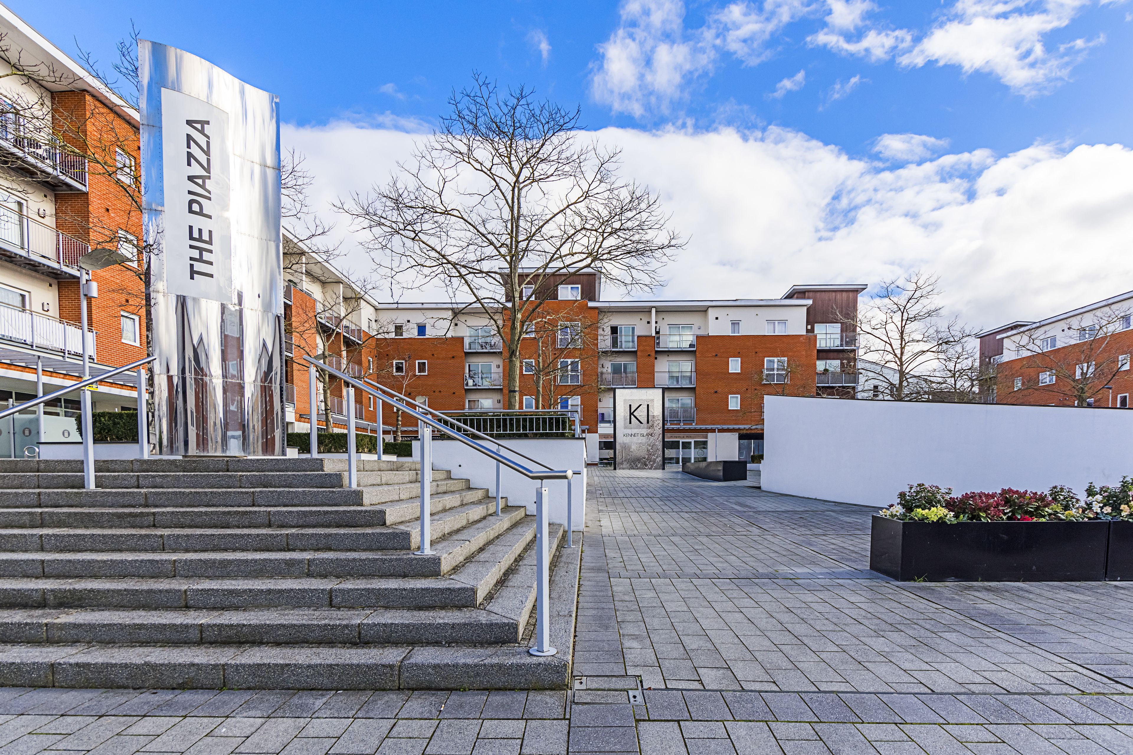 Un bâtiment moderne avec un escalier menant à un espace d’entrée plat.