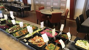 A buffet area with various food stations and seating arrangements.