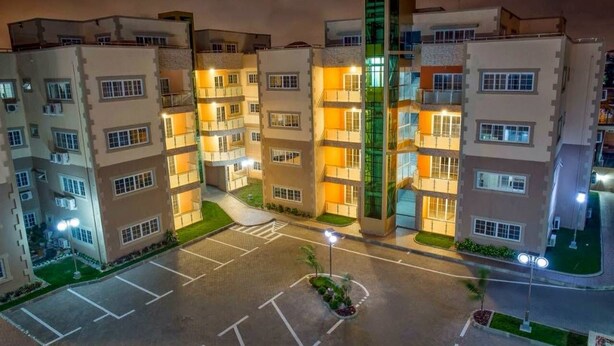 A multi-story residential building with a central courtyard, balconies, and a parking area. - Nkrabea Royal Apartmento (Accra)