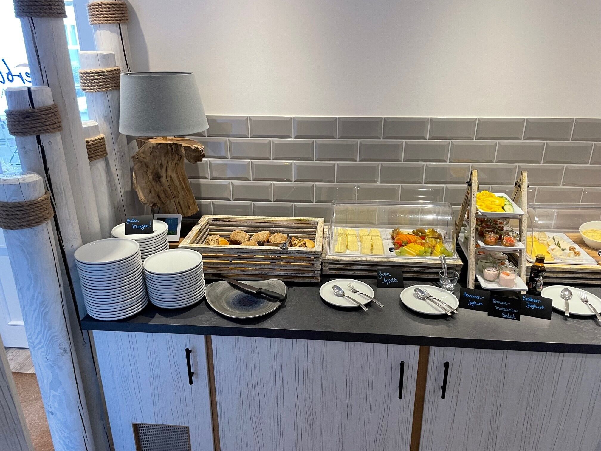 A buffet setup with various food items and utensils.