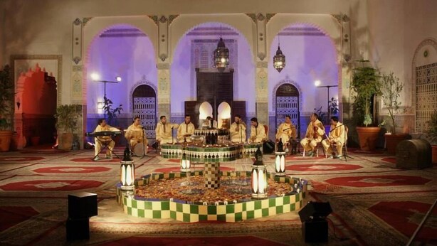 A traditional music performance in a room with arches and ornate decor. - Riad Freija (Freyja)