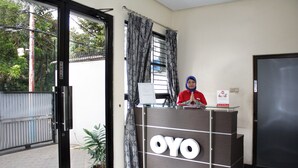 A reception desk with the name "OYO" prominently displayed. - Hotel O Cempaka Place Homestay (Jakarta)