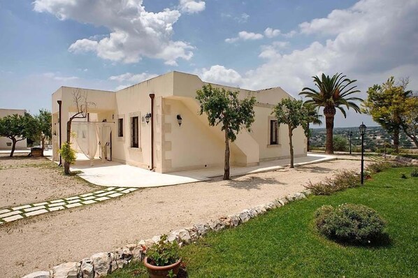 Situated in a serene natural setting, this single-story building features a covered entrance and a small porch area.