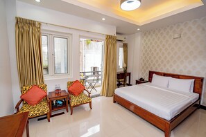 A hotel room with a large bed, two chairs, a small table, and a desk. - Ben Thanh Retreats Hotel (Ho Chi Minh City)