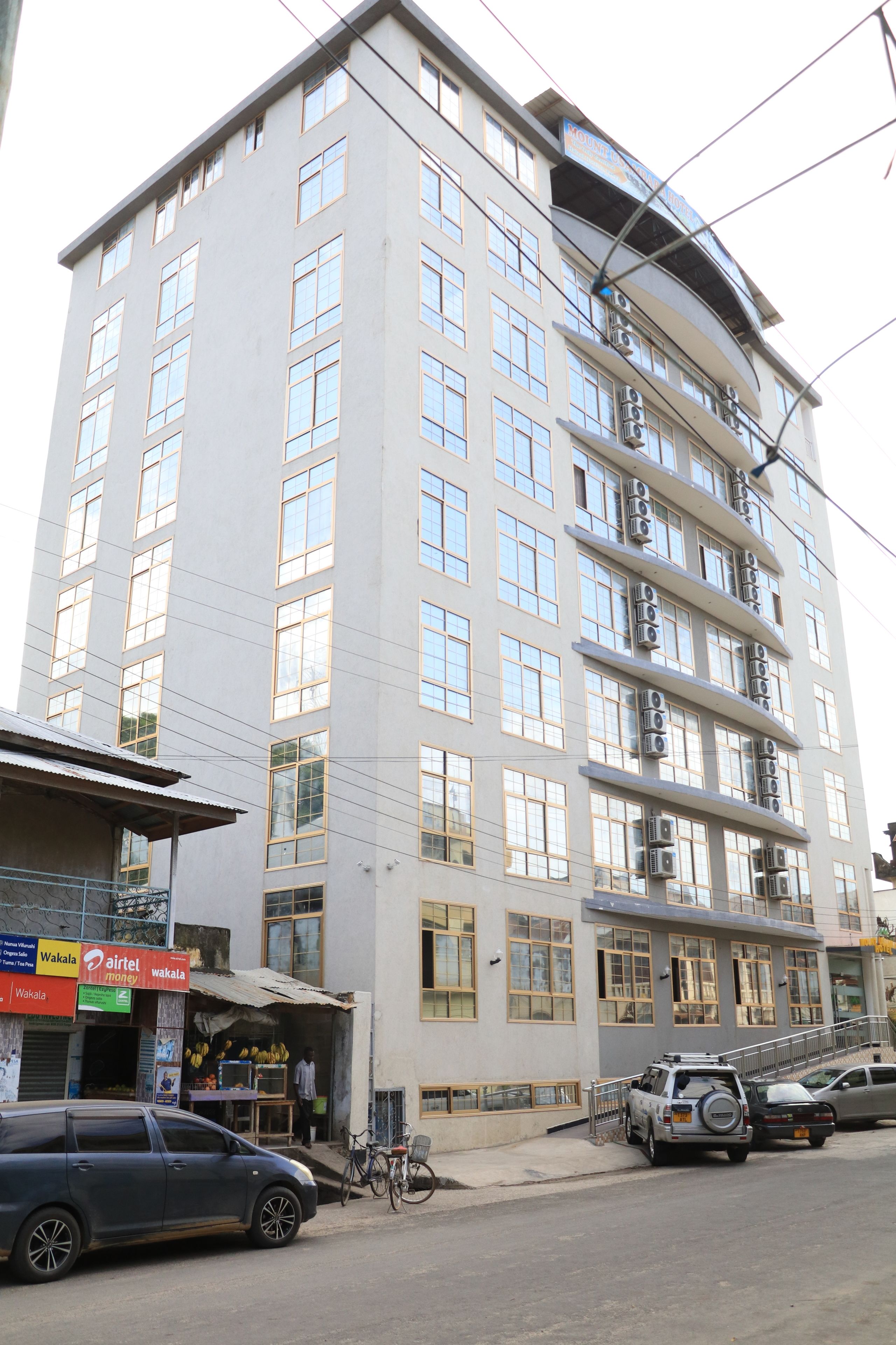 A multi-story building with a modern architectural design, featuring a series of balconies and large windows.