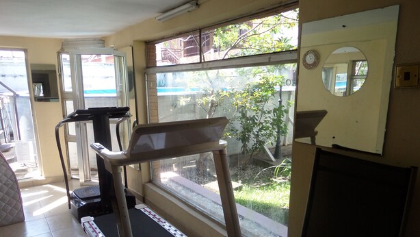A home gym with treadmills, a stationary bike, and a small exercise mat. - House No 12B (Lagos)