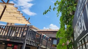 A narrow alley with a stone building, a staircase, and a Coca-Cola vending machine. -  Assos Sunset Boutique Hotel (Ayvacik)
