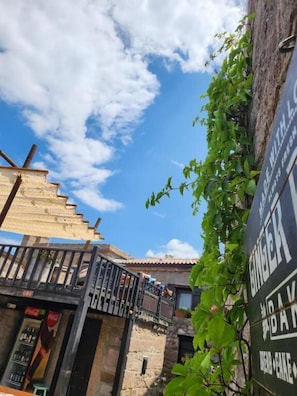 A narrow alley with a stone building, a staircase, and a Coca-Cola vending machine. -  Assos Sunset Boutique Hotel (Ayvacik)