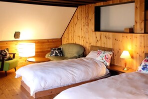 A cozy room with two beds, a green armchair, a small table, and a lamp. - Hakuba Youluri (Hakuba)