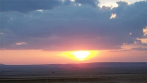 A sunset over a flat landscape with no visible structures or amenities. - Hostal Las Grullas (Tornos)