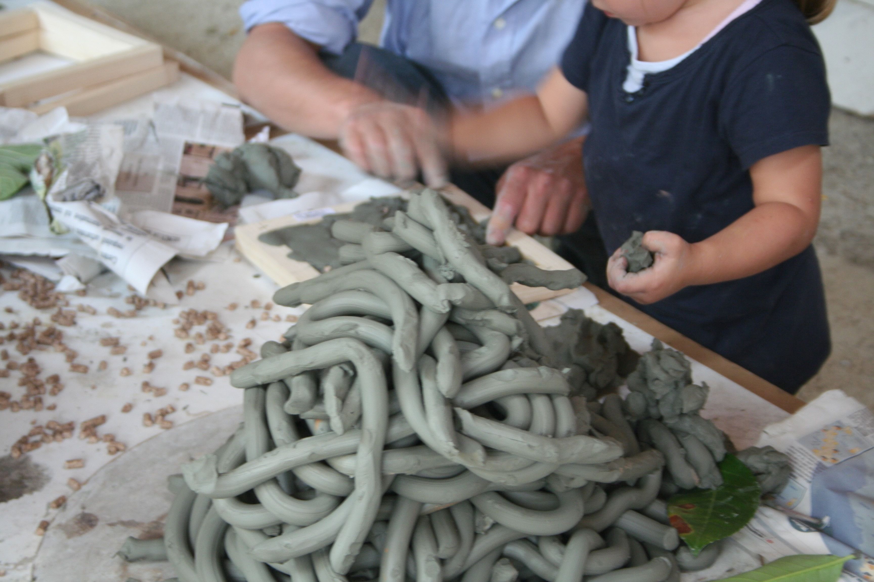A person working with clay on a table.