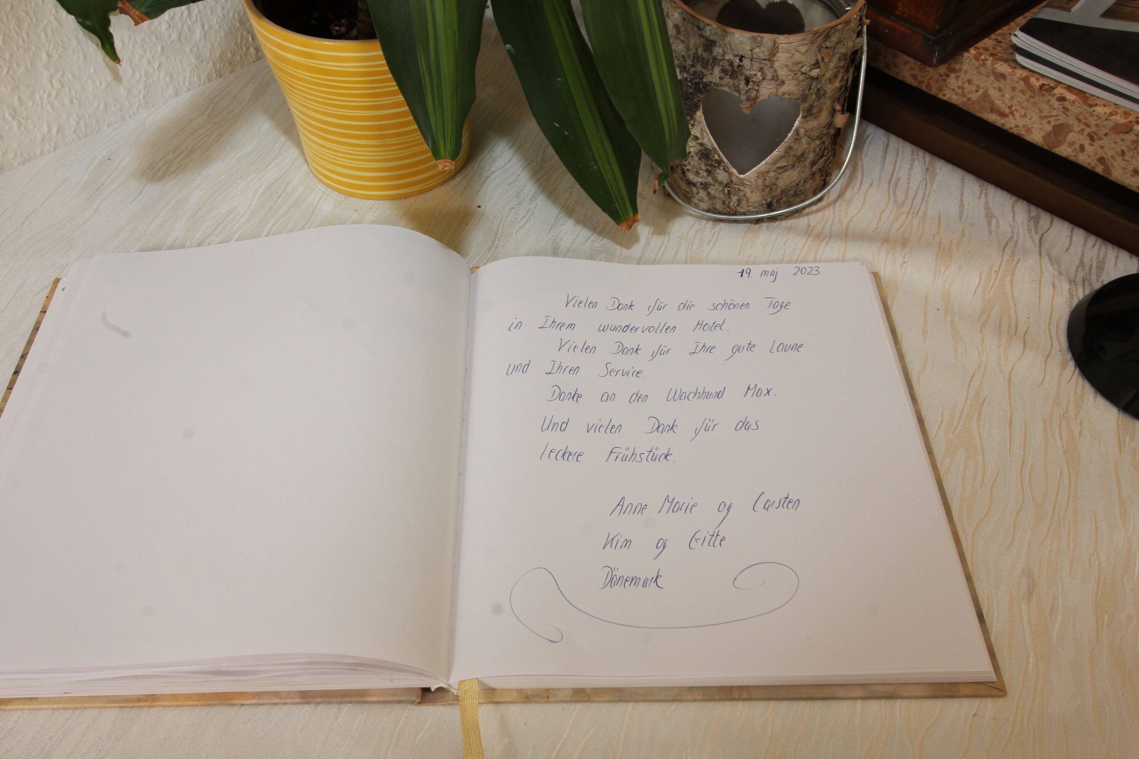An open notebook on a wooden surface with handwritten notes.