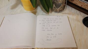 An open notebook on a wooden surface with handwritten notes.