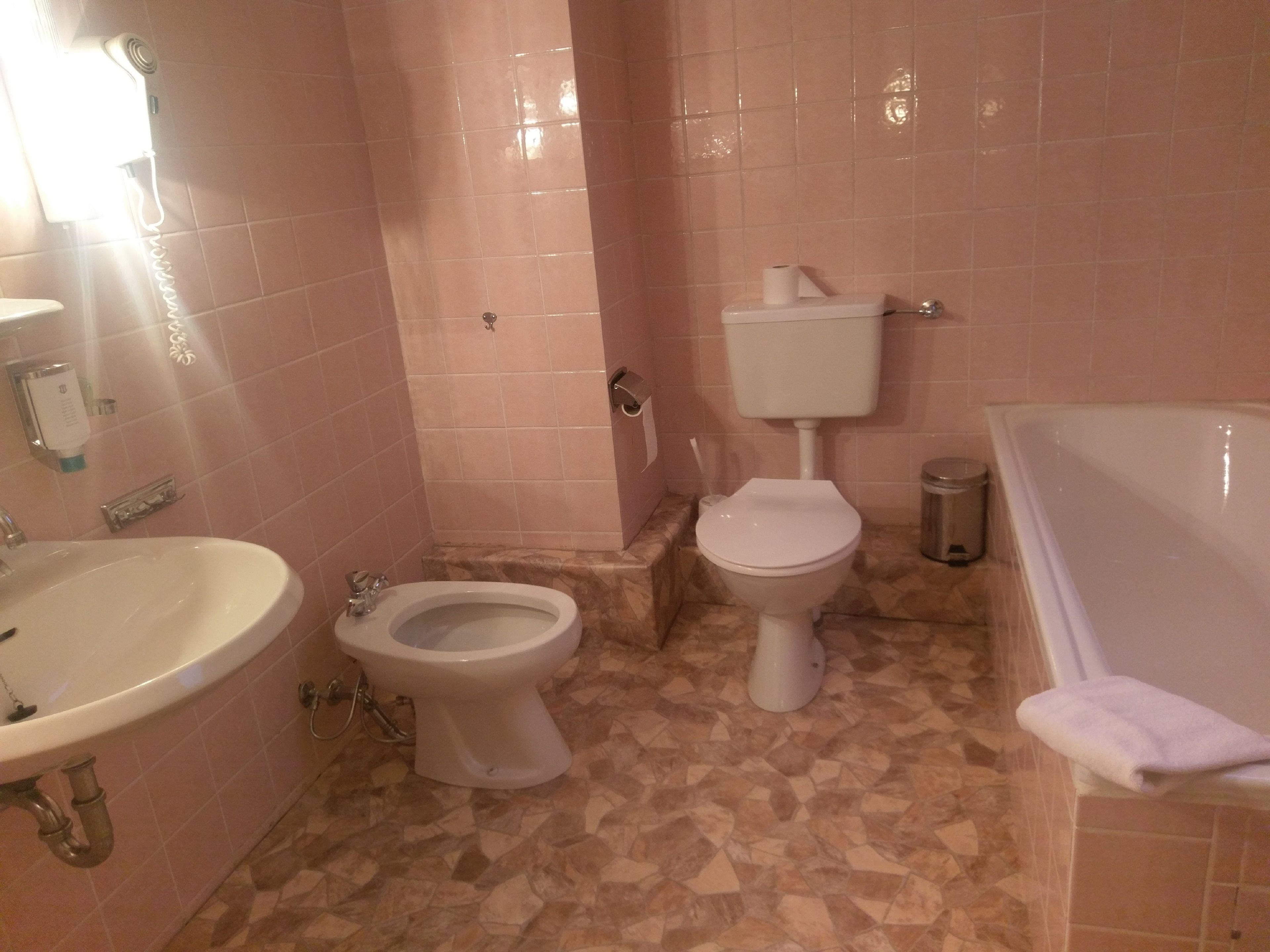 A bathroom with a sink, toilet, and bathtub.