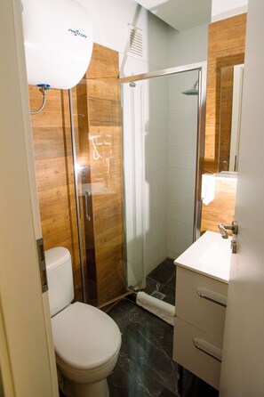 Quadruple Studio | Bathroom | Shower, hair dryer, towels, soap - Ermou Downtown Studios by Hospitality Box (Athens)