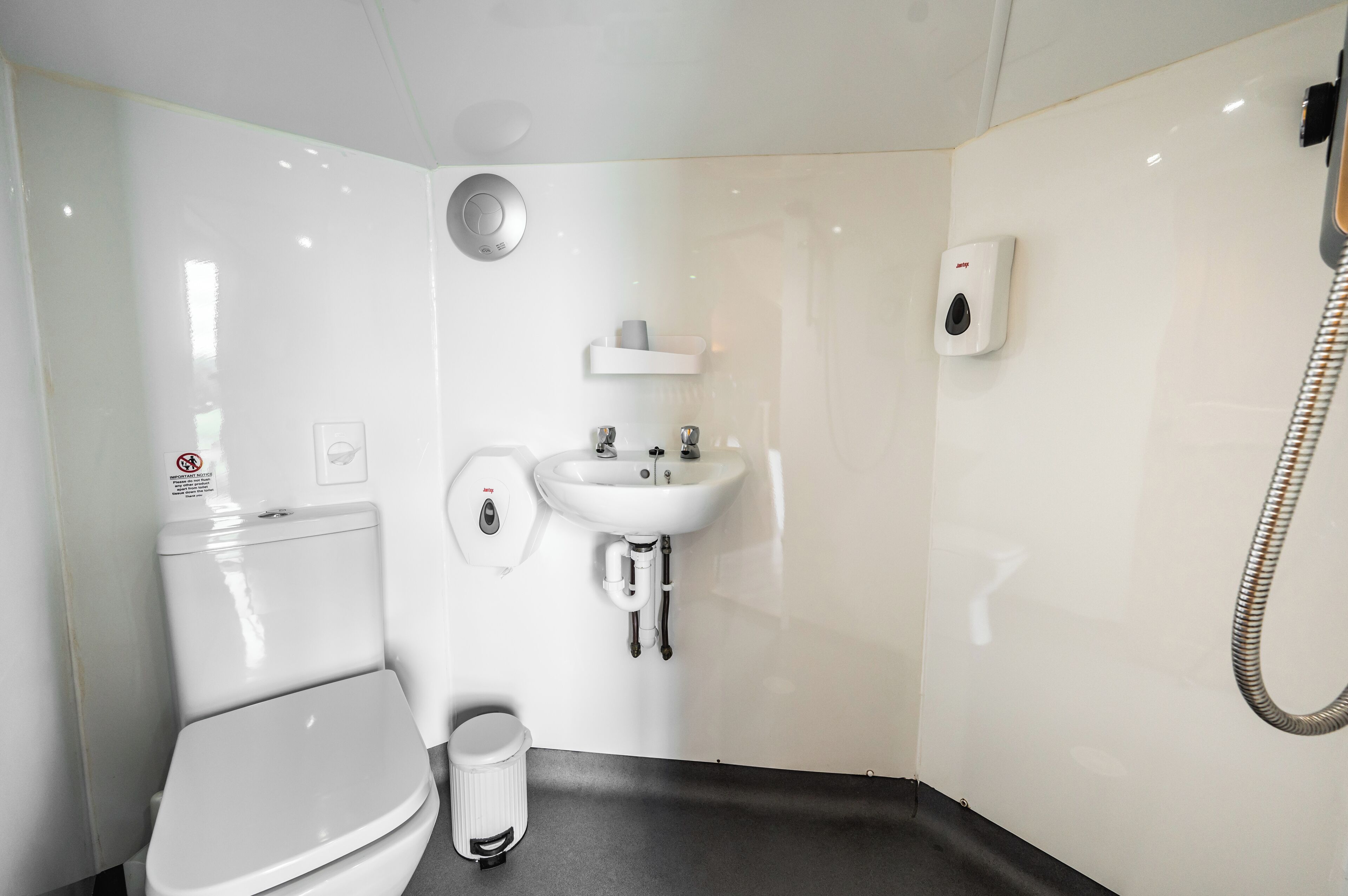 Un baño moderno con inodoro, lavabo y ducha.