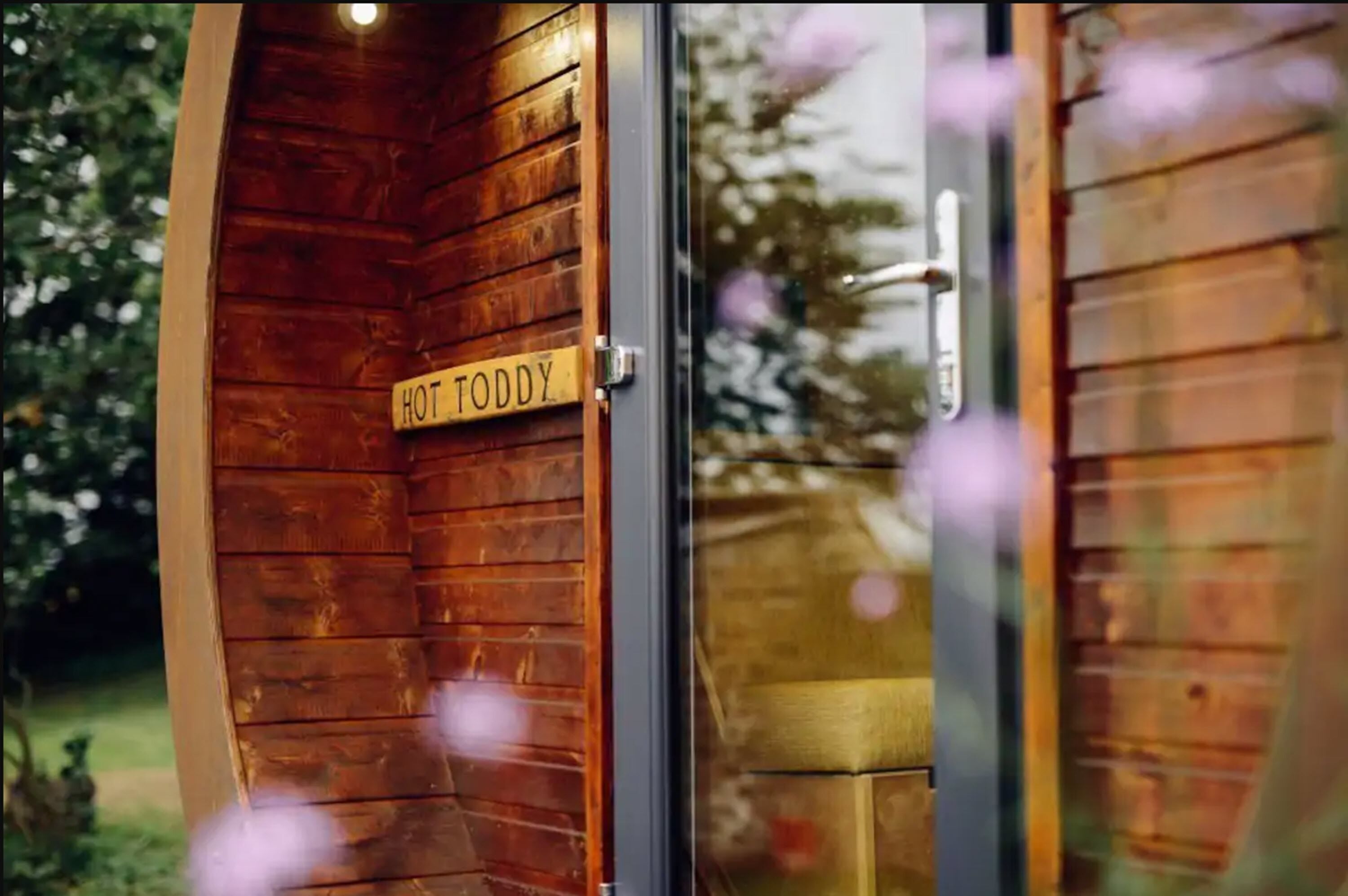 A wooden door with a sign reading "HOT TODDY".