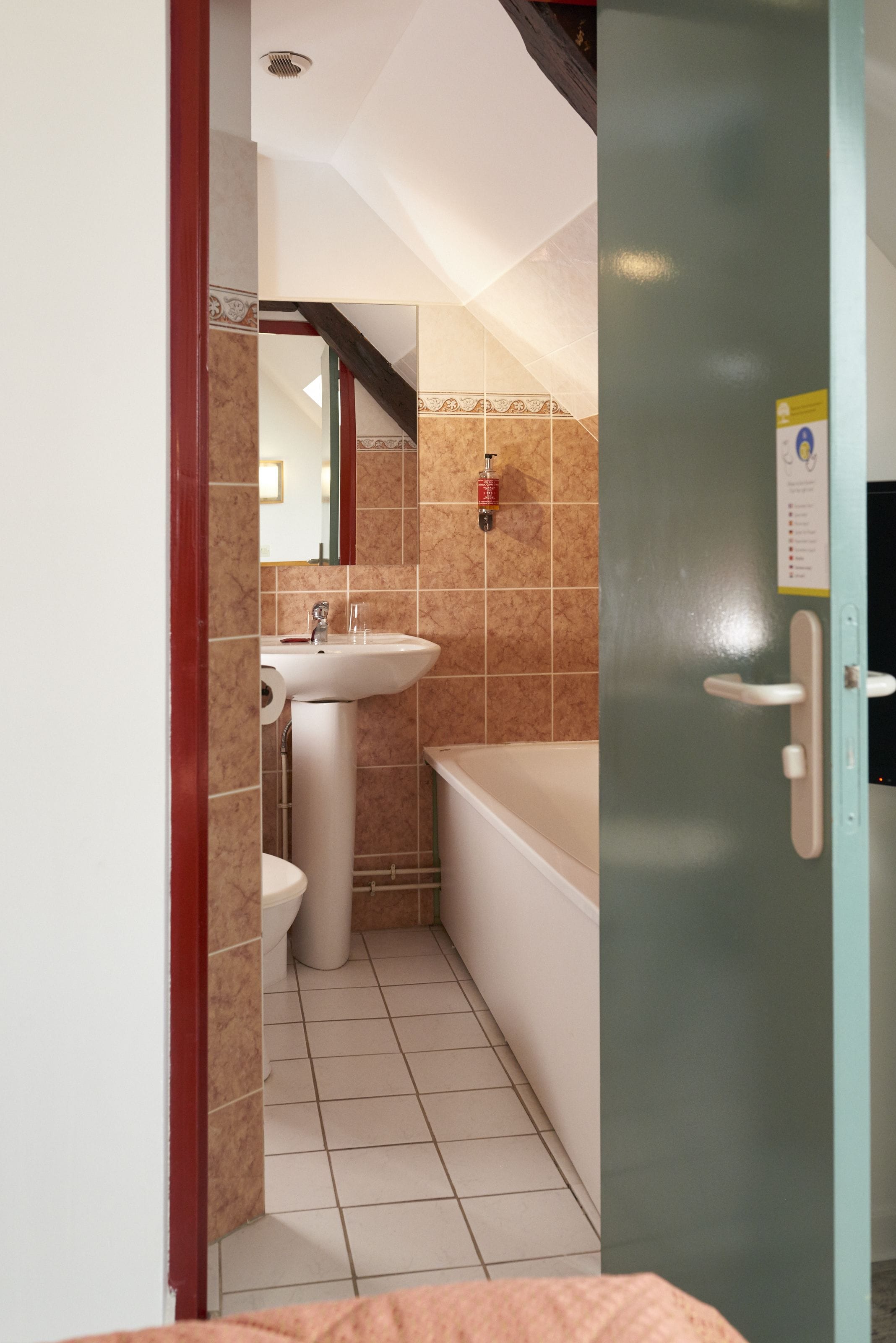 A bathroom with a sink, toilet, and bathtub.