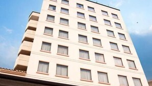 A multi-story hotel with a flat facade, numerous windows, and a covered entrance area. - Shimabara Station Hotel (Shimabara)