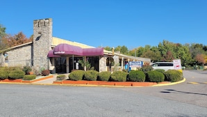 A SuperLodge building with a stone facade, a purple awning, and a 'No Entry' sign. - Superlodge (New Castle)