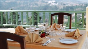 A table set for two with a view of mountains in the background. - Dar Ismail Nour Elain (Ain Draham)