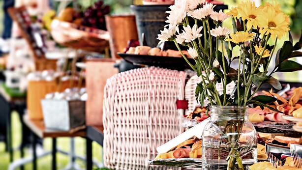 A table with a variety of food items and a vase of flowers. - Hotel Lagoon (Rionegro)