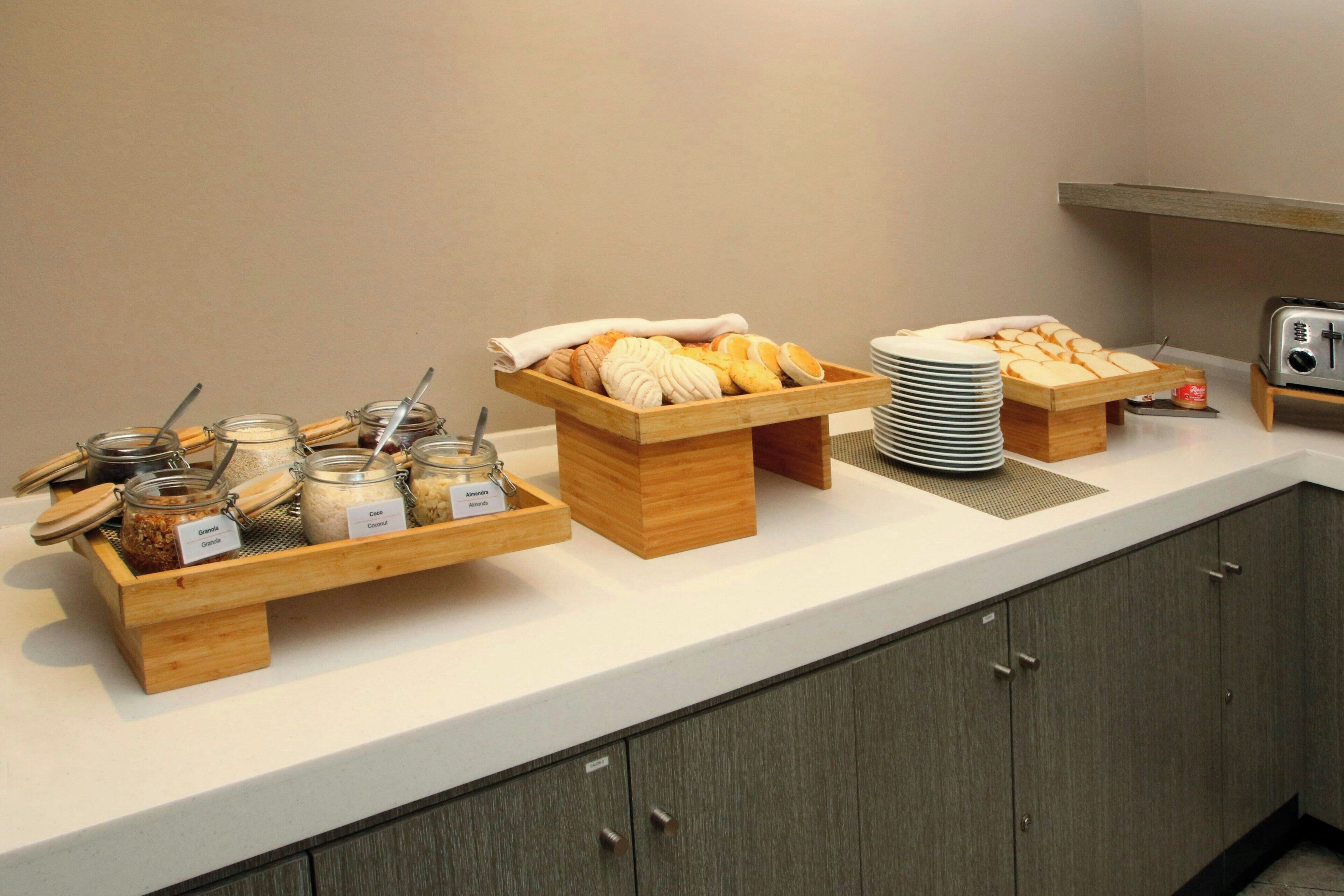 A buffet setup with various food items and utensils.