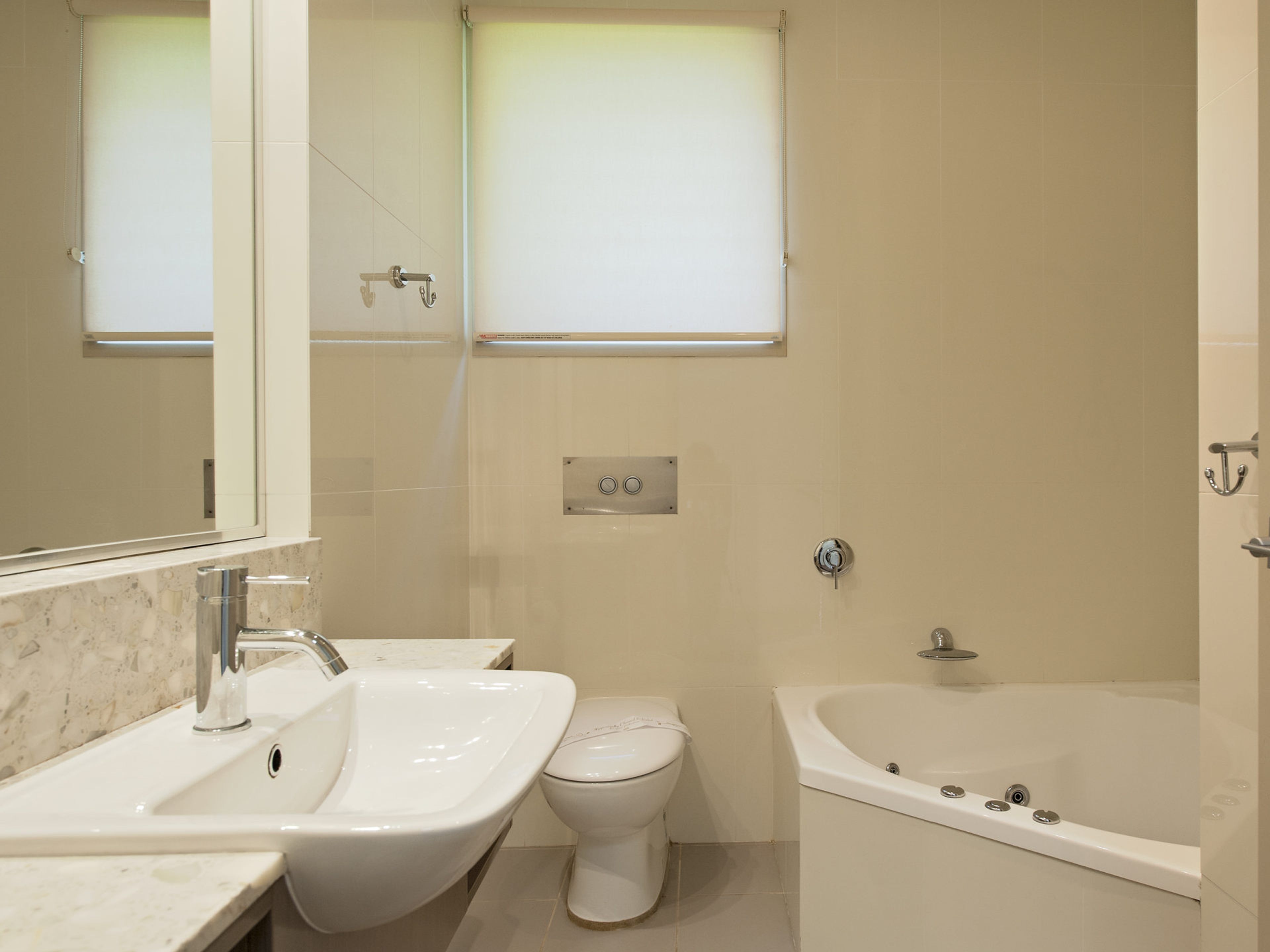 A bathroom with a sink, toilet, and bathtub.