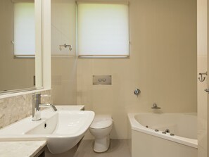 A bathroom with a sink, toilet, and bathtub.