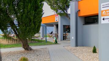 A building with a sign indicating a women's restroom and a snack bar.