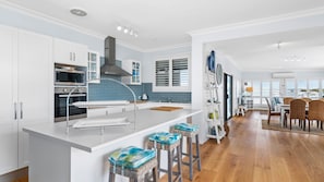Enjoy cooking in this well-equipped kitchen with a large island, double oven, and sink.