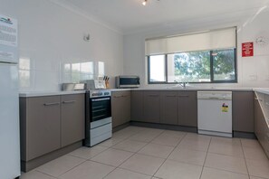 A modern kitchen with a built-in oven, microwave, and dishwasher.