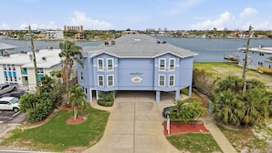 A two-story building with a flat roof, a balcony on the second floor, and a sign that reads 'AMADEU.' - Amadeus 3 Amazing Water view|Steps to beach|Top location! (Treasure Island)